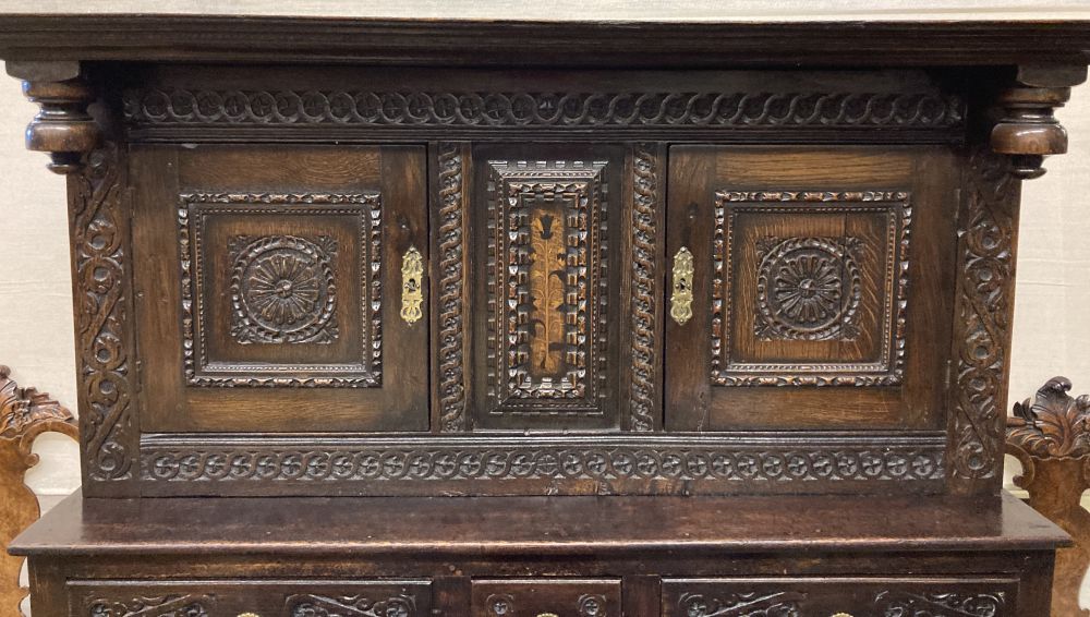 A late 18th century carved oak court cupboard, width 130cm, depth 52cm, height 170cm